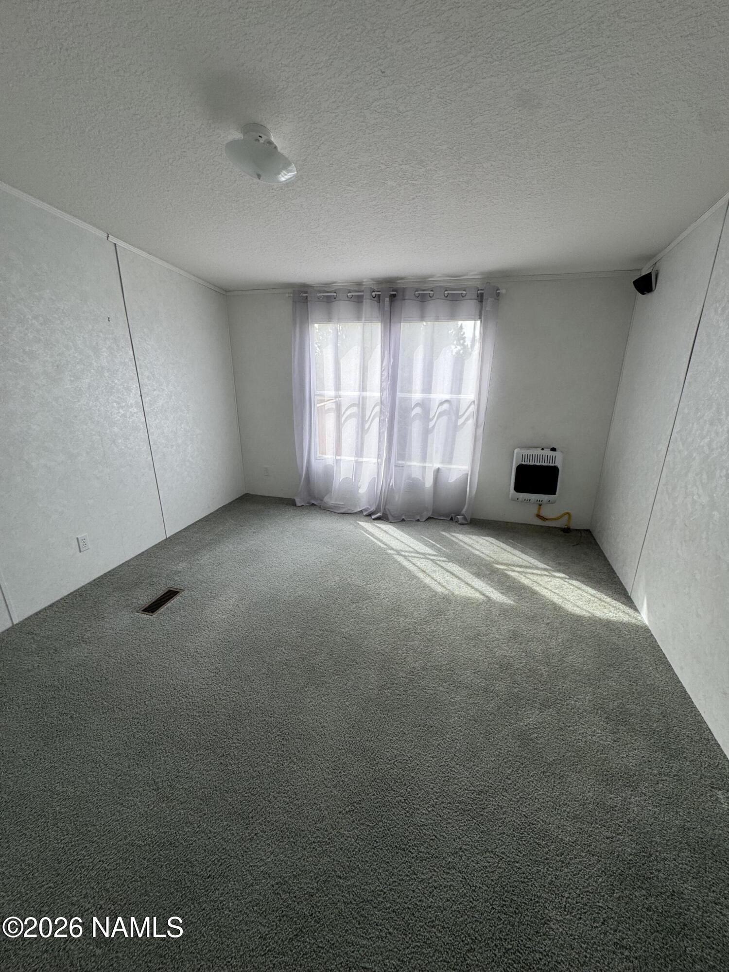768 Mountain Cat Road Williams, AZ 86046 - Photo 21 of 37 a view of an empty room with a window