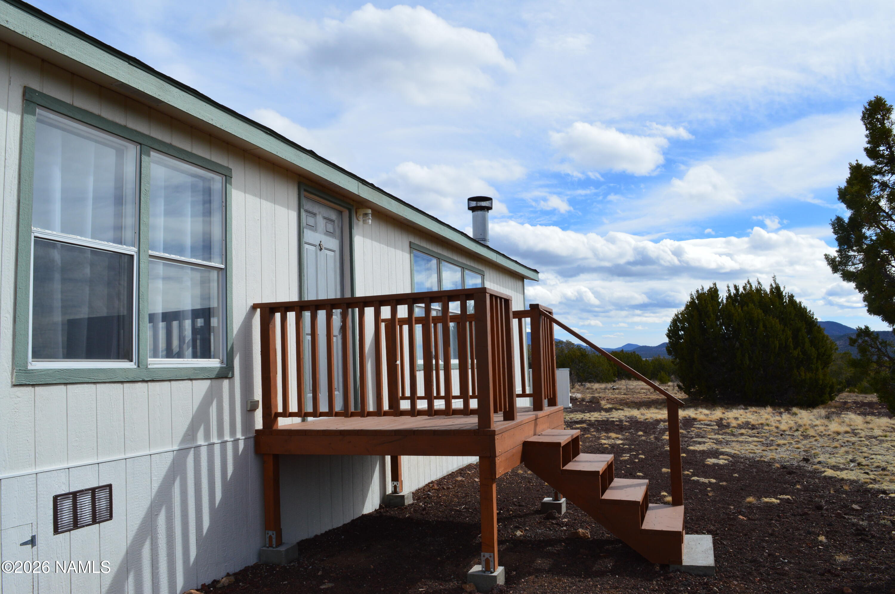 768 Mountain Cat Road Williams, AZ 86046 - Photo 4 of 37 a roof deck with table and chairs