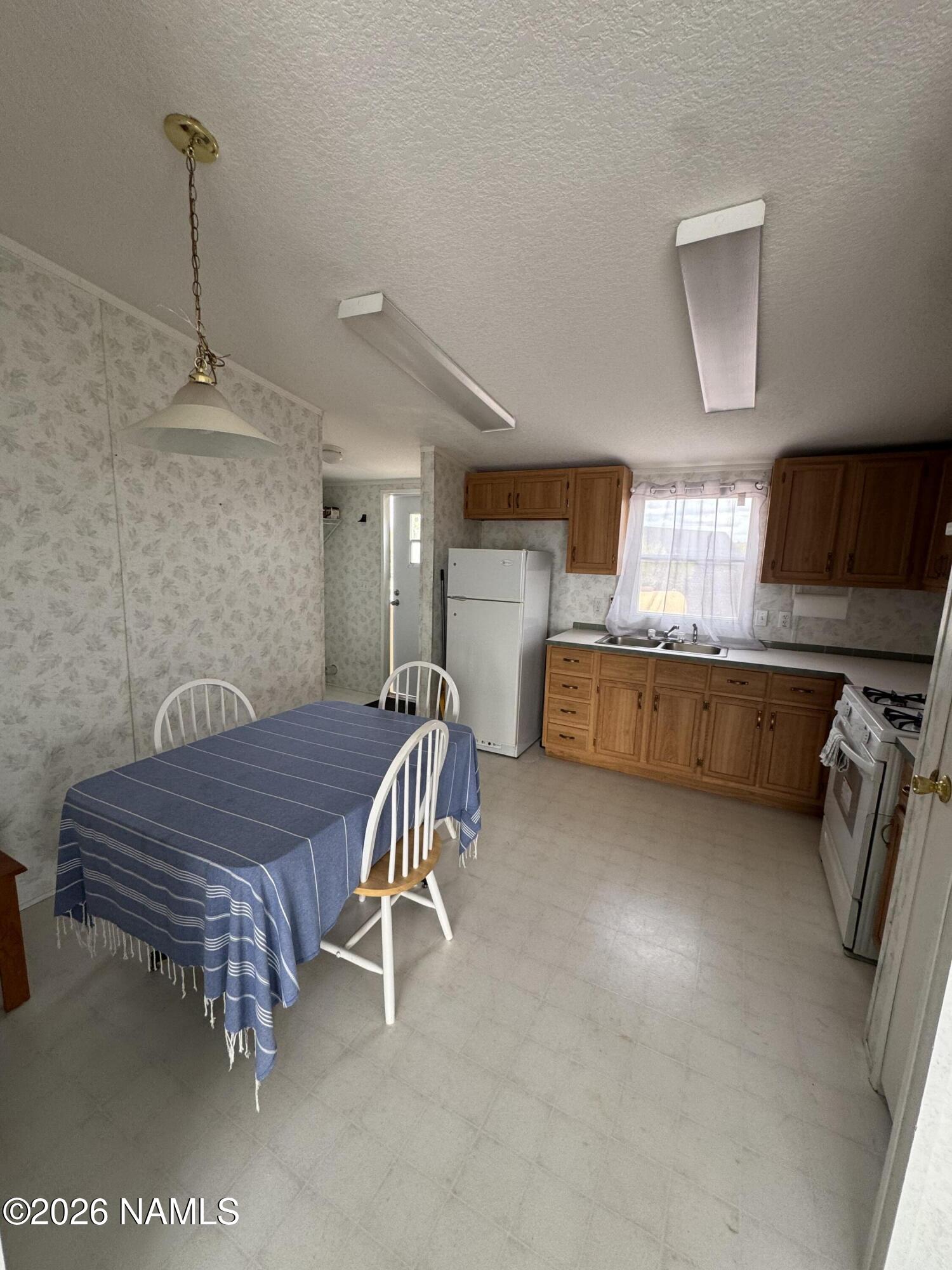 768 Mountain Cat Road Williams, AZ 86046 - Photo 10 of 37 a bedroom with furniture and a flat screen tv