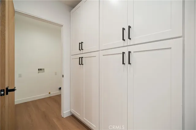 a view of a hallway with wooden floor