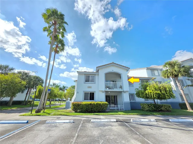 a front view of a house with a yard and plants
