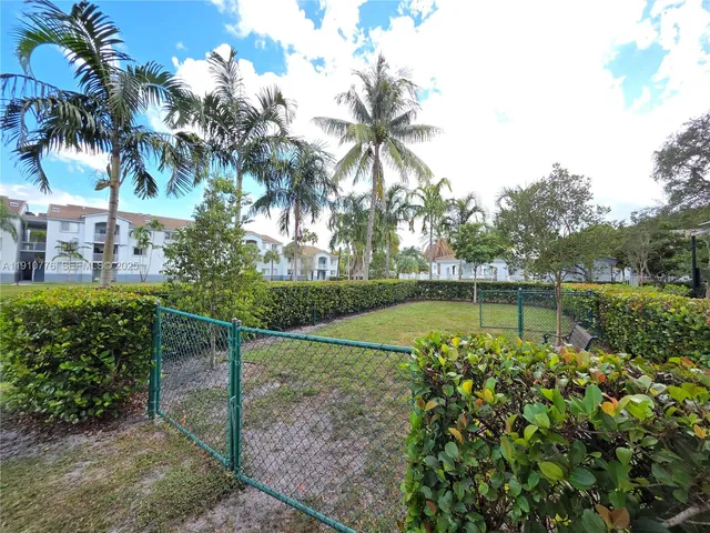 a kitchen with stainless steel appliances kitchen island granite countertop a table and chairs in it