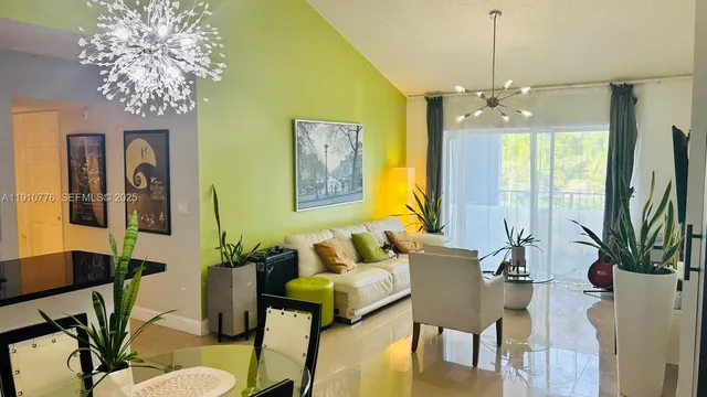 a kitchen with stainless steel appliances kitchen island granite countertop a refrigerator a stove and a dining table