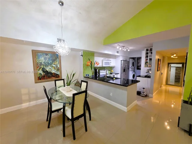 a kitchen with stainless steel appliances granite countertop a sink a stove and a refrigerator