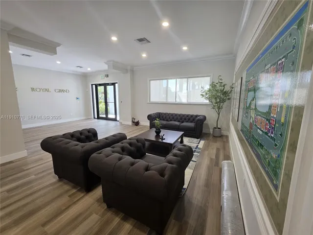 a living room with furniture a large window and a wooden floor