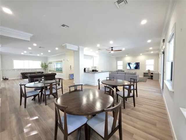 a large living room with stainless steel appliances kitchen island a large counter top and couch