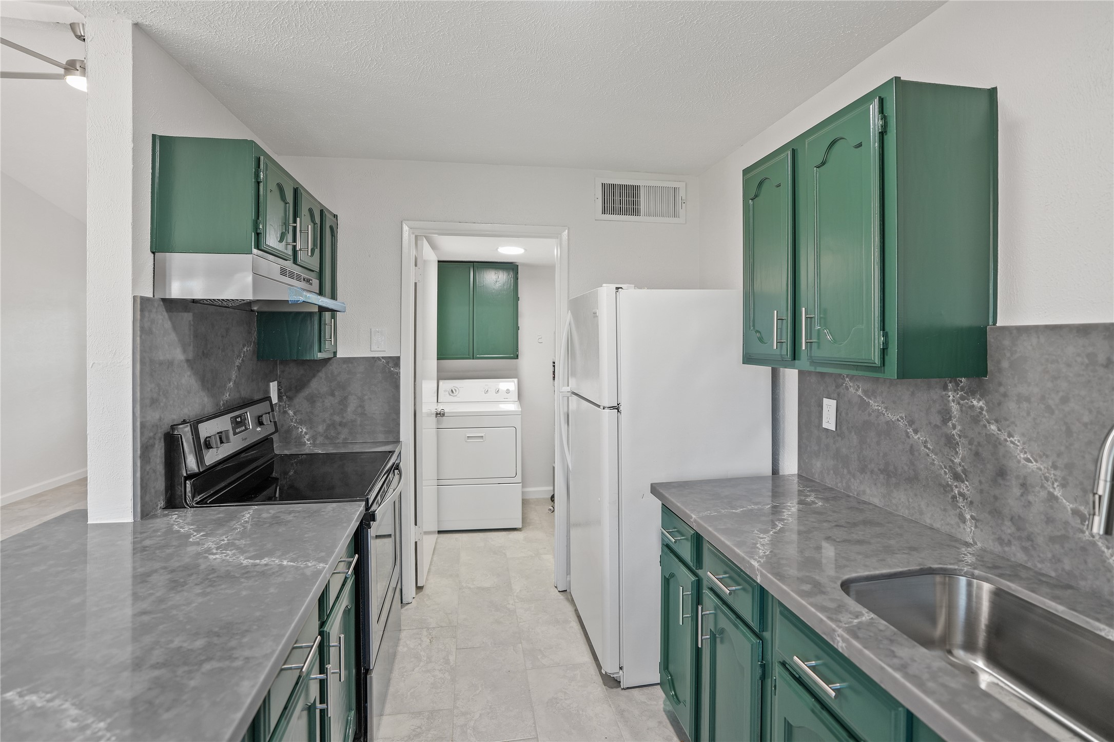 6610 Blue Ridge Drive Richmond, TX 77469 - Photo 10 of 24 The kitchen is conveniently adjacent to the utility room which adds extra practicality and storage space.