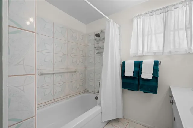 a bathroom with a bathtub and a shower