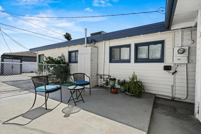a view of a patio with table and chairs and potted plants
