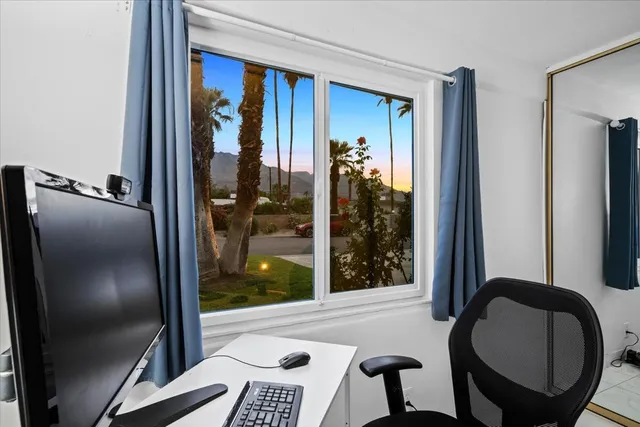 a view of a patio with chairs under an umbrella