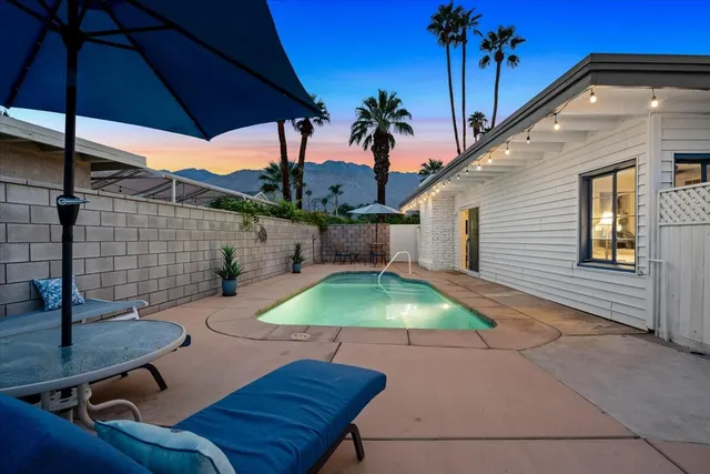 a patio with table and chairs