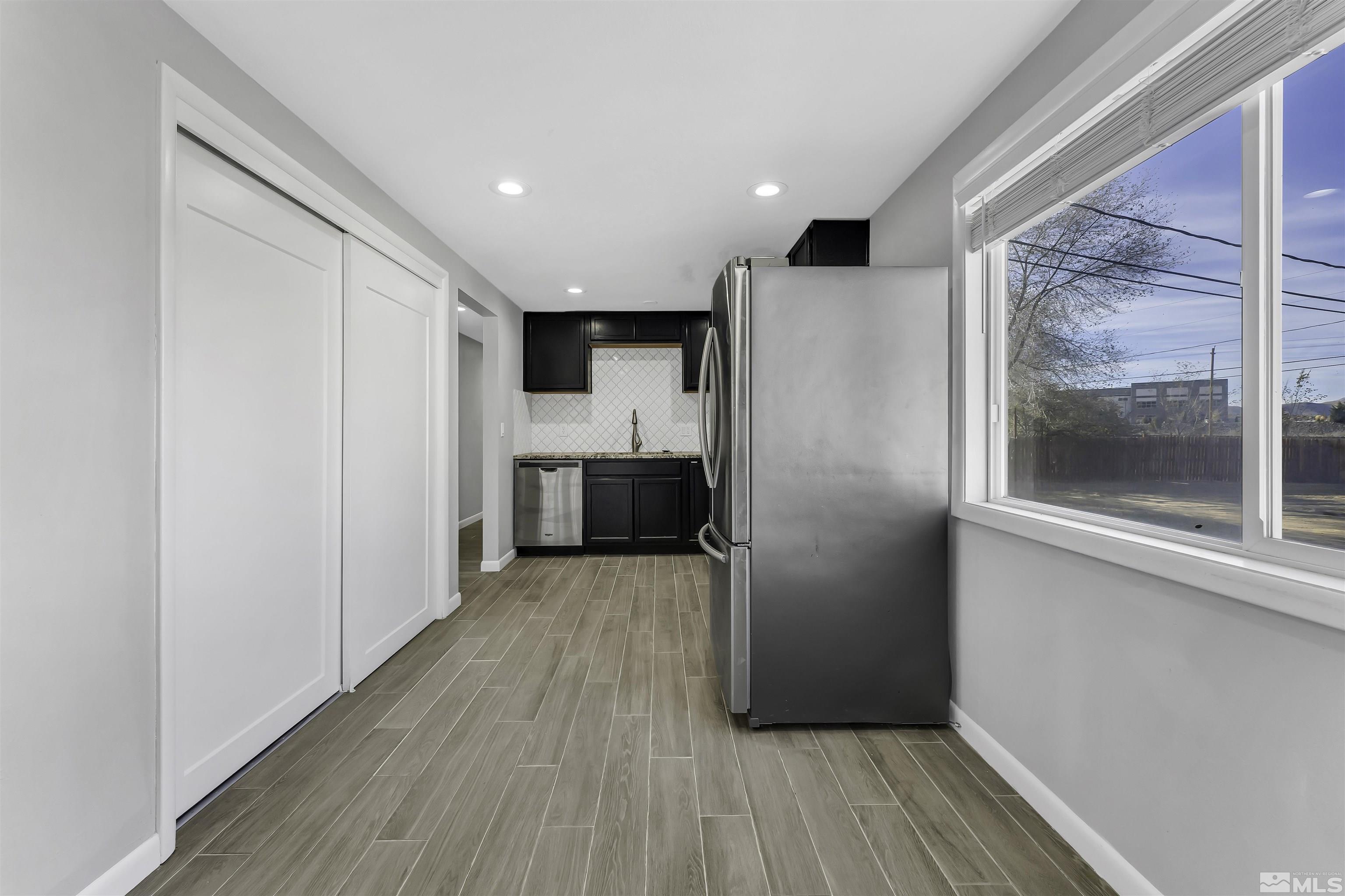 8625 Channel Way Reno, NV 89506 - Photo 11 of 29 a view of a hallway with wooden floor and a refrigerator