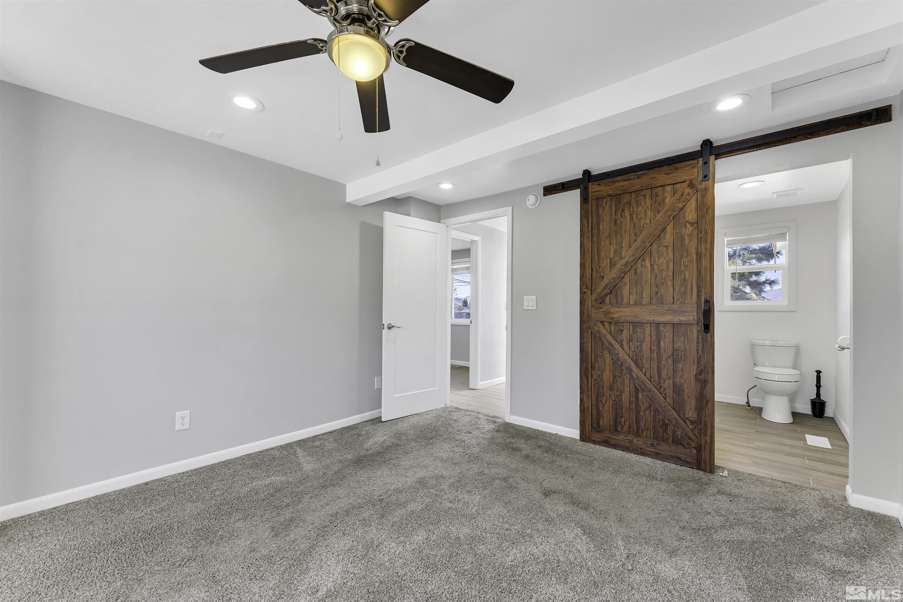 8625 Channel Way Reno, NV 89506 - Photo 14 of 29 en empty room with fan and entryway