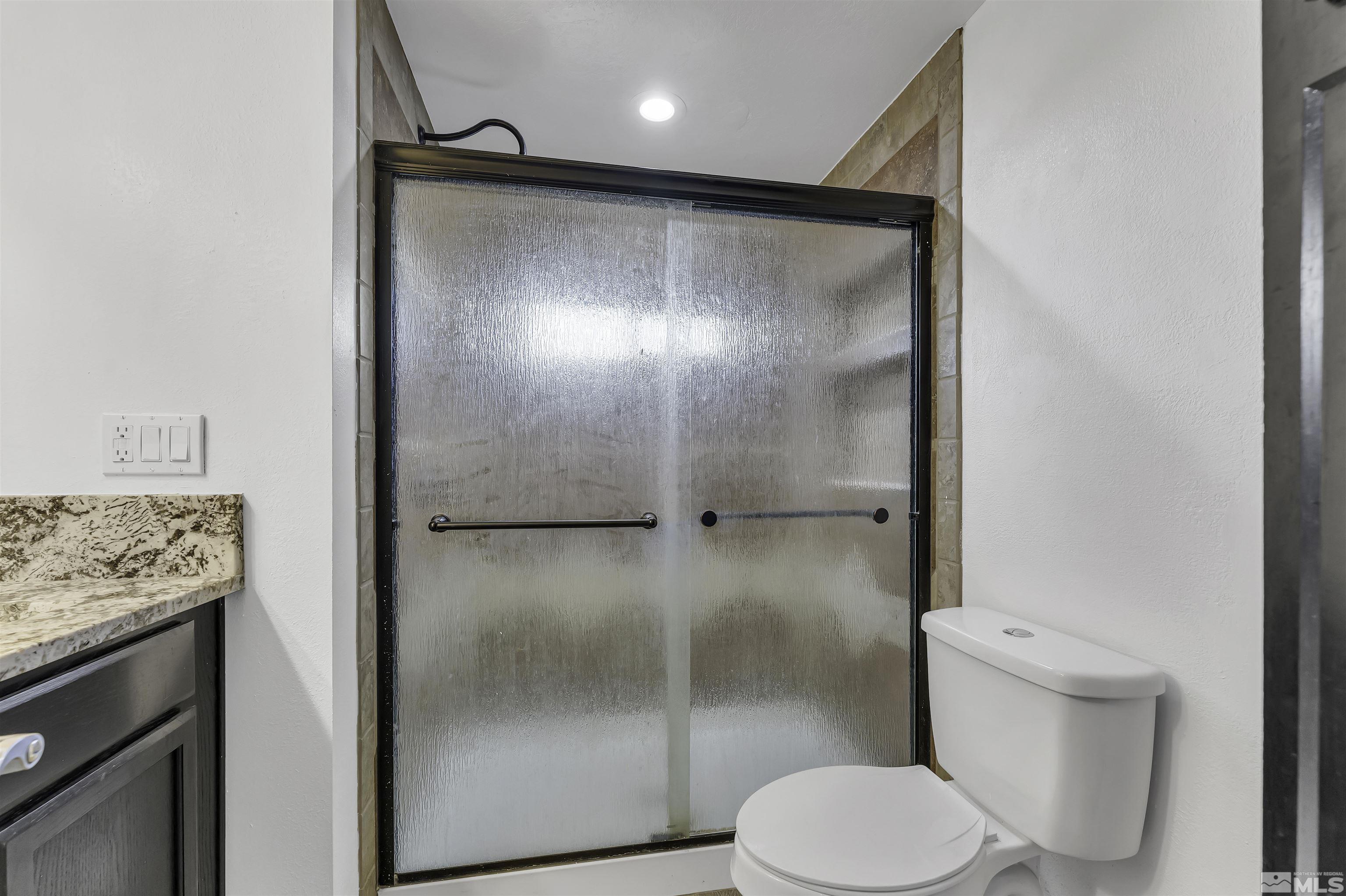 8625 Channel Way Reno, NV 89506 - Photo 18 of 29 a bathroom with a shower and a toilet