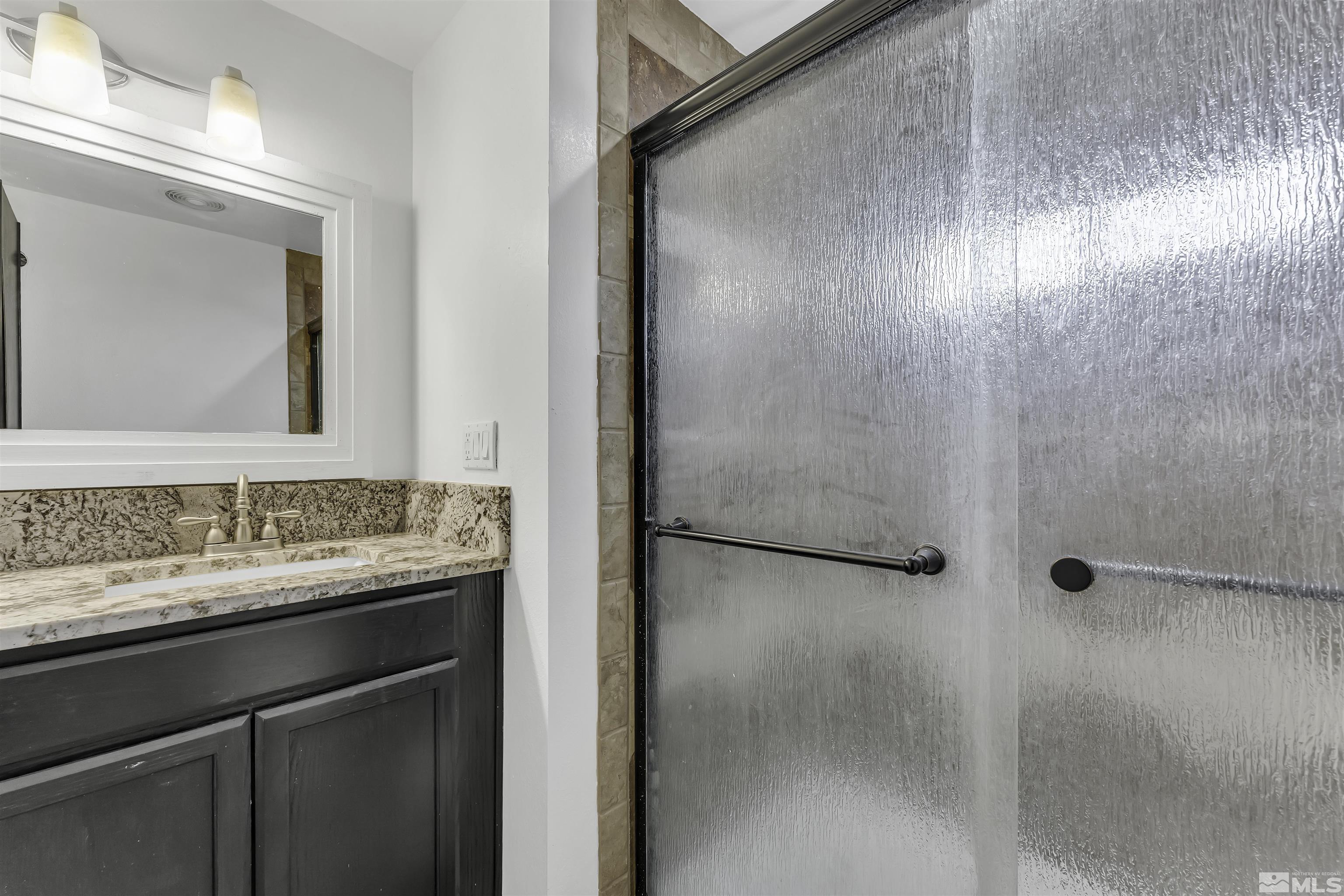 8625 Channel Way Reno, NV 89506 - Photo 19 of 29 a bathroom with a granite countertop sink and a mirror