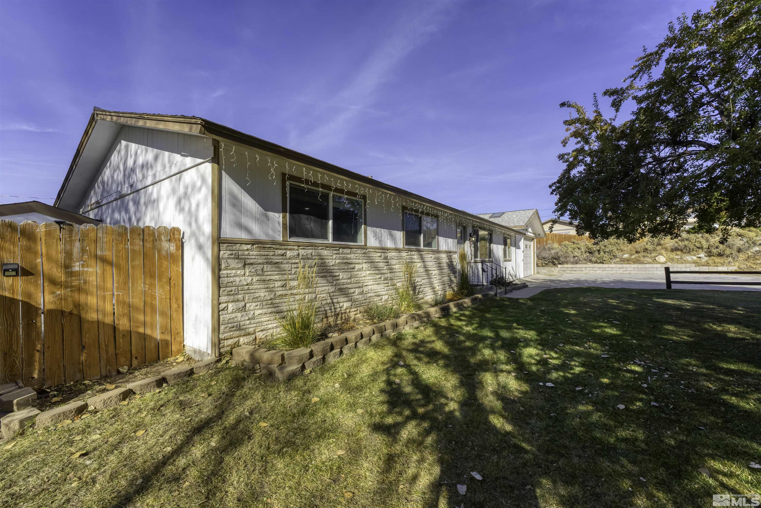 8625 Channel Way Reno, NV 89506 - Photo 3 of 29 a backyard of a house with lots of green space