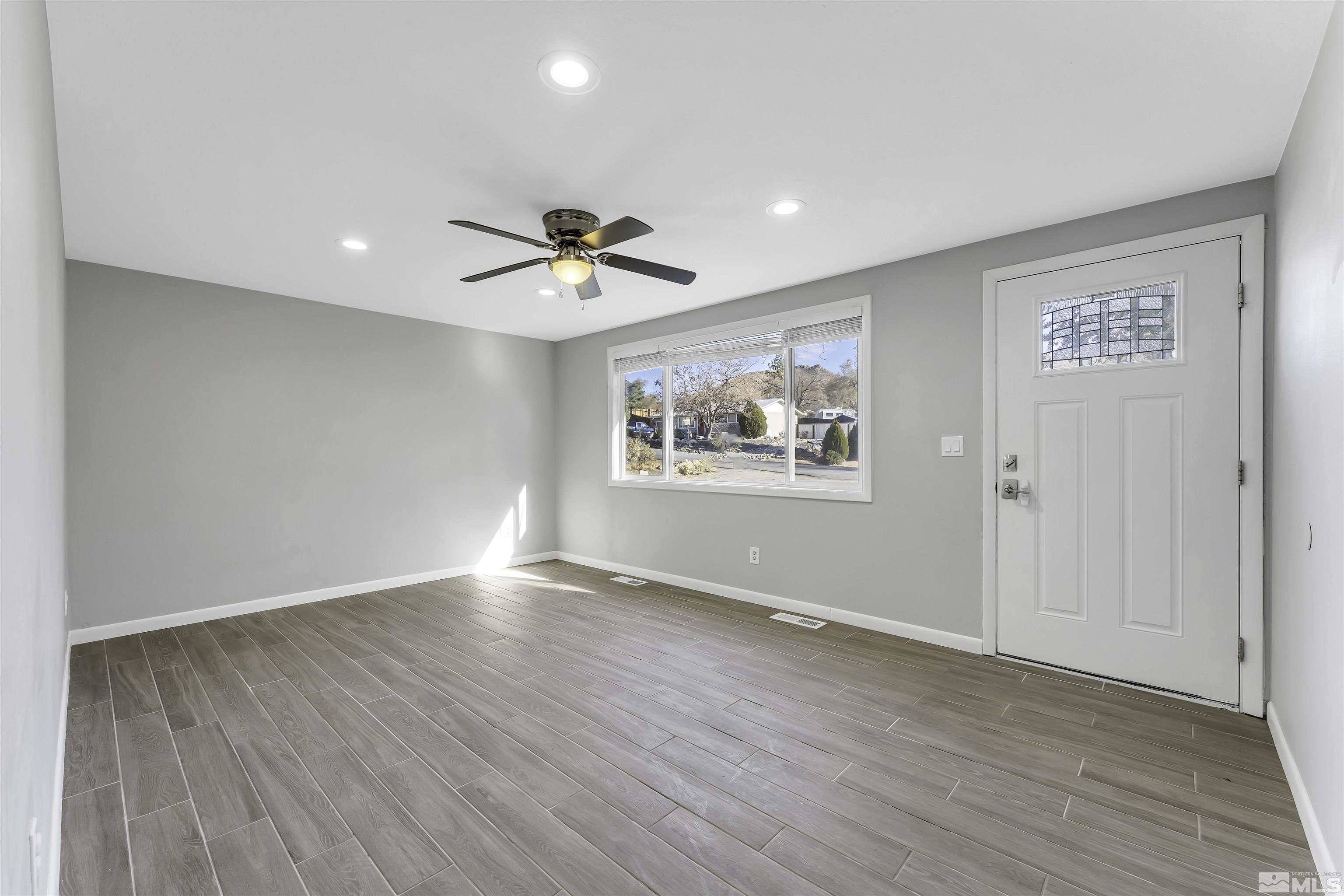 8625 Channel Way Reno, NV 89506 - Photo 5 of 29 wooden floor in an empty room with a window