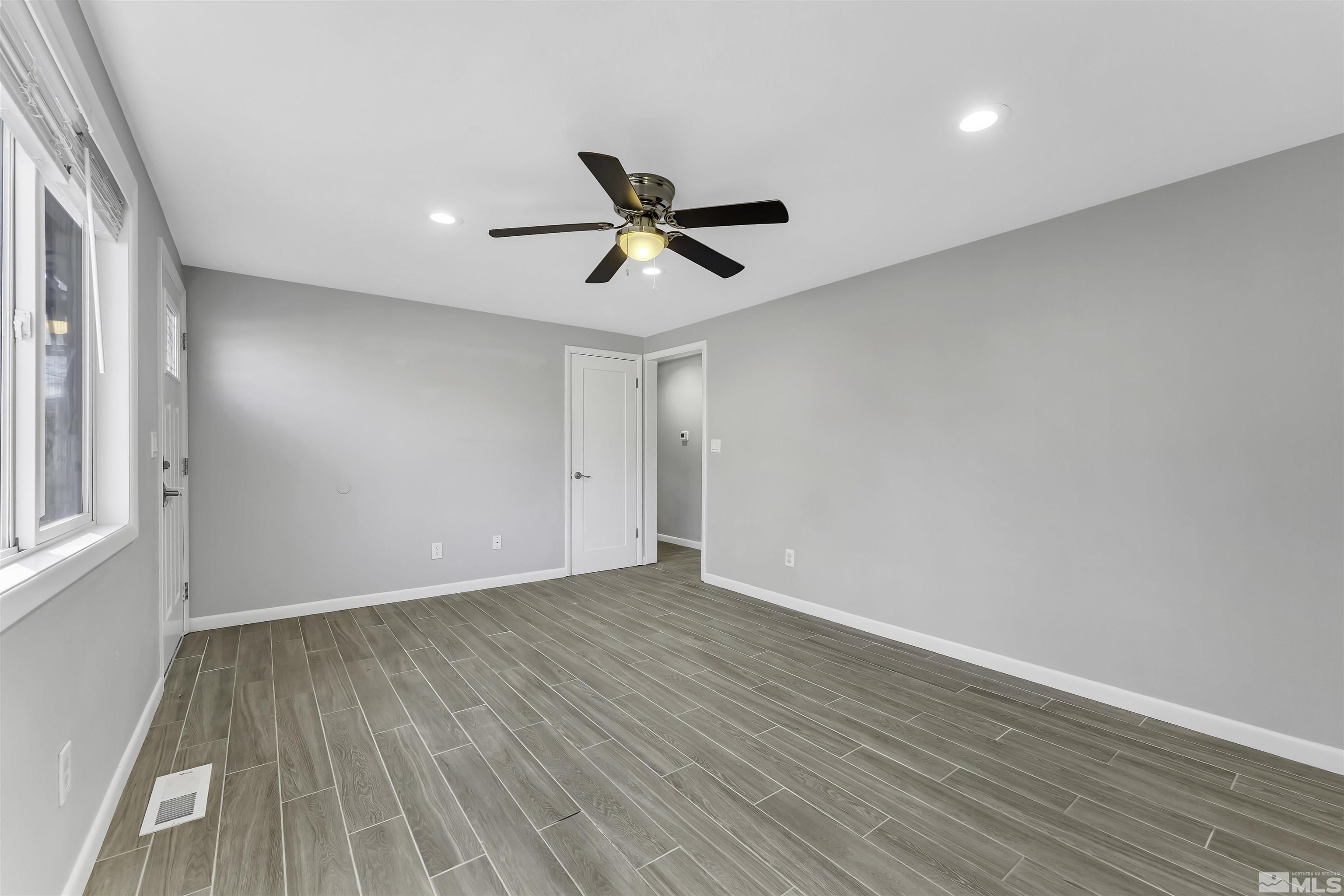 8625 Channel Way Reno, NV 89506 - Photo 6 of 29 wooden floor in an empty room with a window