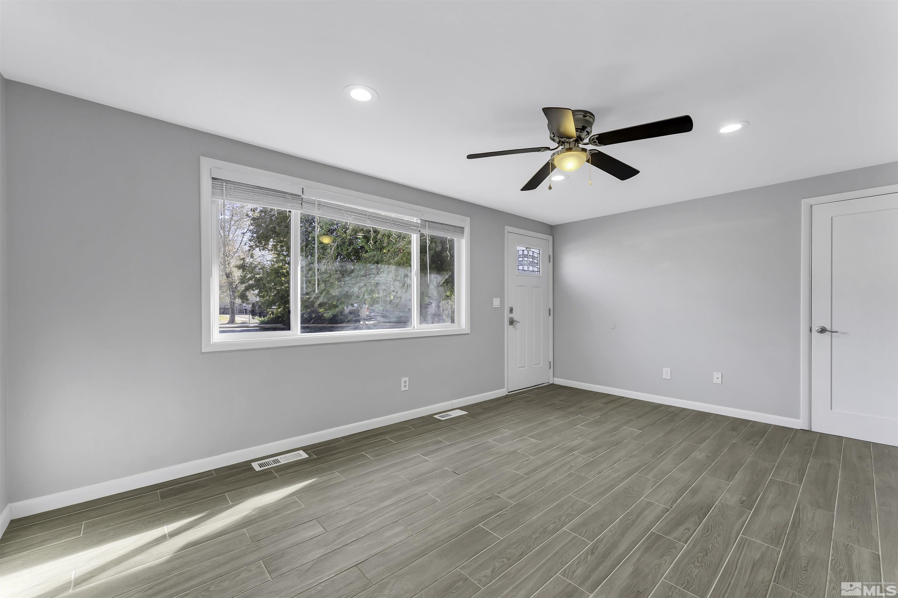 8625 Channel Way Reno, NV 89506 - Photo 7 of 29 wooden floor in an empty room with a window