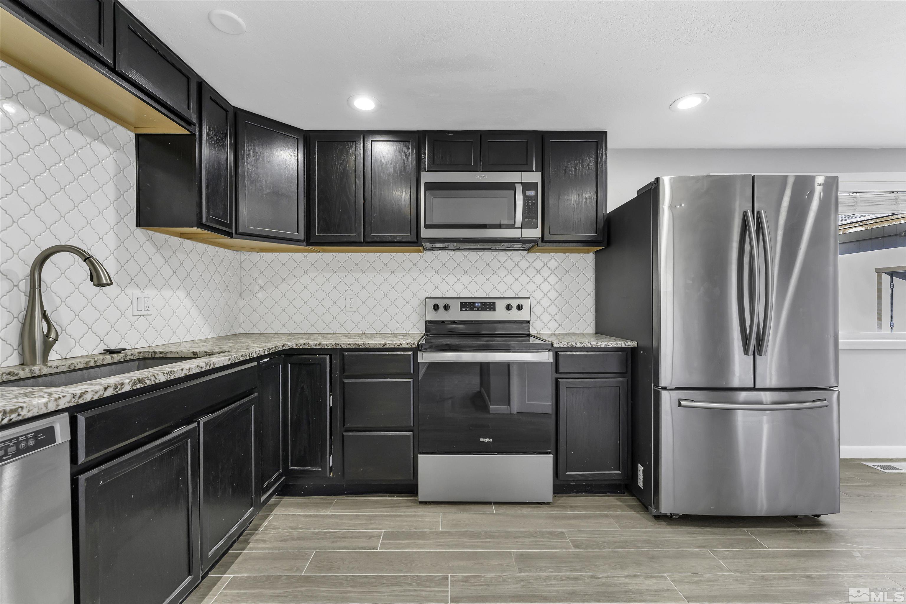 8625 Channel Way Reno, NV 89506 - Photo 9 of 29 a kitchen with stainless steel appliances granite countertop a refrigerator stove and sink