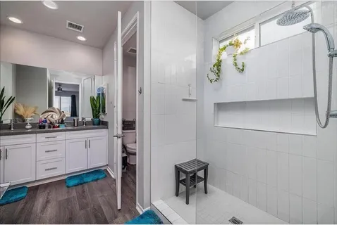 a spacious bathroom with a sink a mirror and a shower