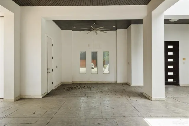 an empty room with a door and a mirror