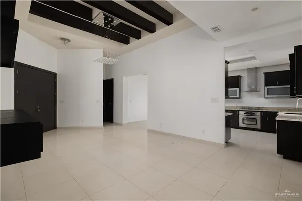 a view of kitchen with microwave and refrigerator