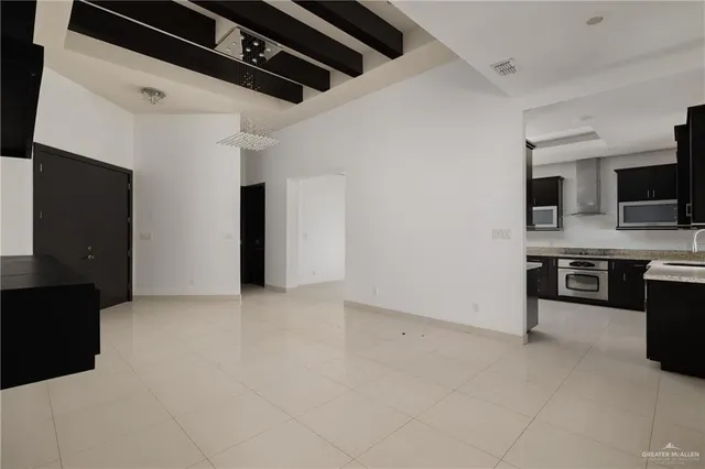 a view of kitchen with microwave and refrigerator