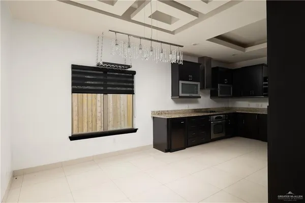 a kitchen with stainless steel appliances a stove sink and cabinets