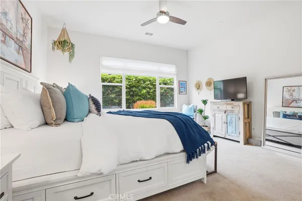 a bedroom with a bed and a window