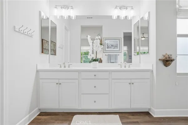 a bedroom with a bed and a flat tv screen next to a window