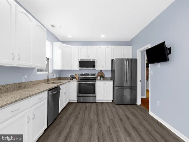 a kitchen with a refrigerator stove and microwave