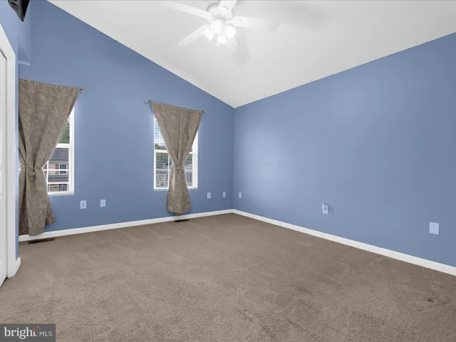 an empty room with windows and closet