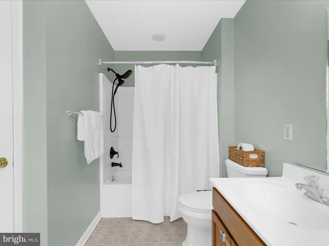 a bathroom with a sink vanity mirror and toilet