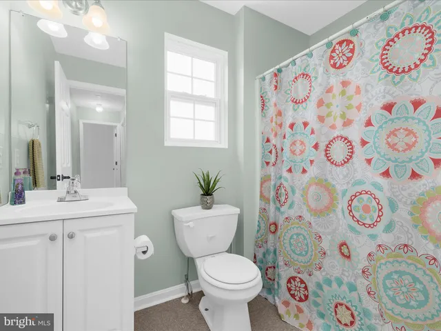 a bathroom with a sink and mirror with toilet