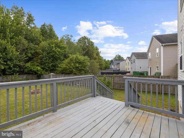 a view of balcony with wooden floor and fence