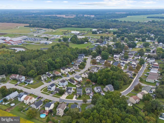 an aerial view of lake residential houses with outdoor space and swimming pool