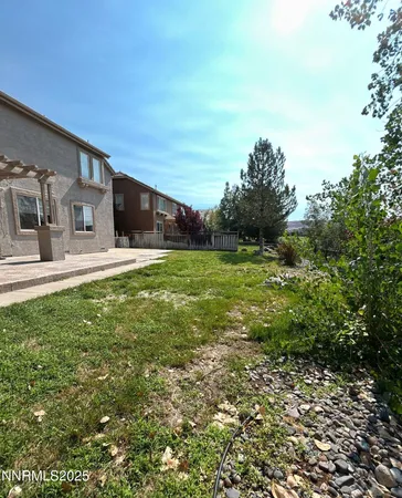 a backyard of a house with table and chairs