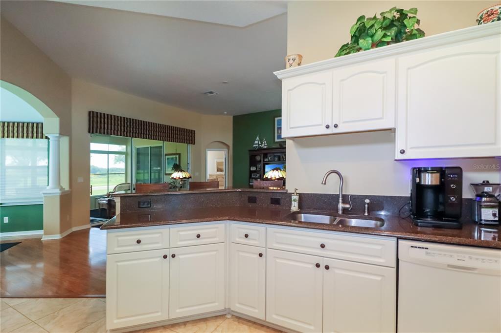 27328 Pine Straw Road Leesburg, FL 34748 - Photo 12 of 32 a kitchen with white cabinets and a window