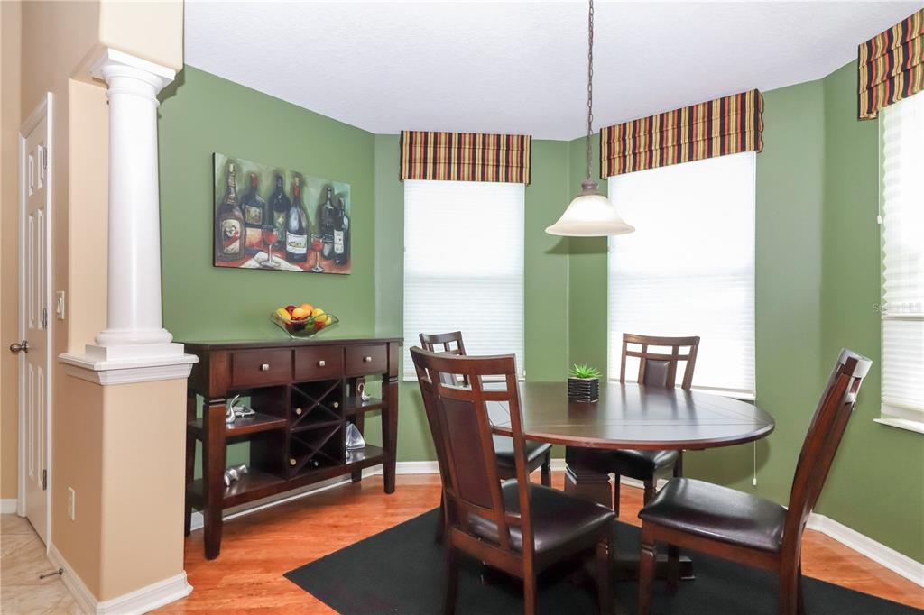 27328 Pine Straw Road Leesburg, FL 34748 - Photo 13 of 32 a view of a dining room with furniture and wooden floor