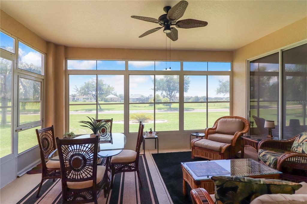 27328 Pine Straw Road Leesburg, FL 34748 - Photo 21 of 32 a living room with furniture and a floor to ceiling window
