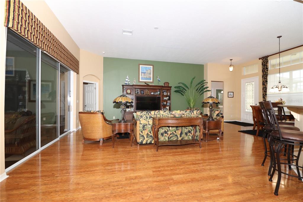 27328 Pine Straw Road Leesburg, FL 34748 - Photo 7 of 32 a living room with furniture and a flat screen tv