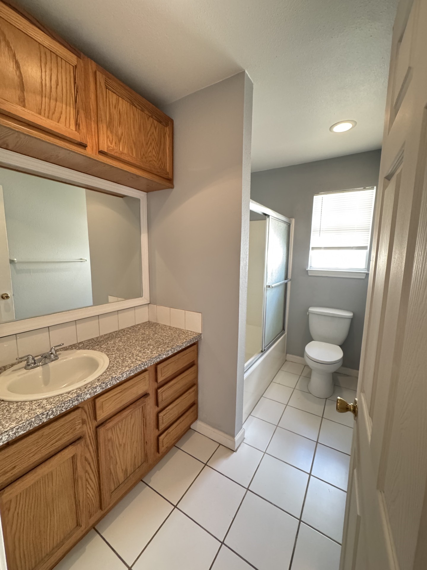 216 Gale Street Houston, TX 77009 - Photo 11 of 12 a bathroom with a granite countertop sink and a mirror