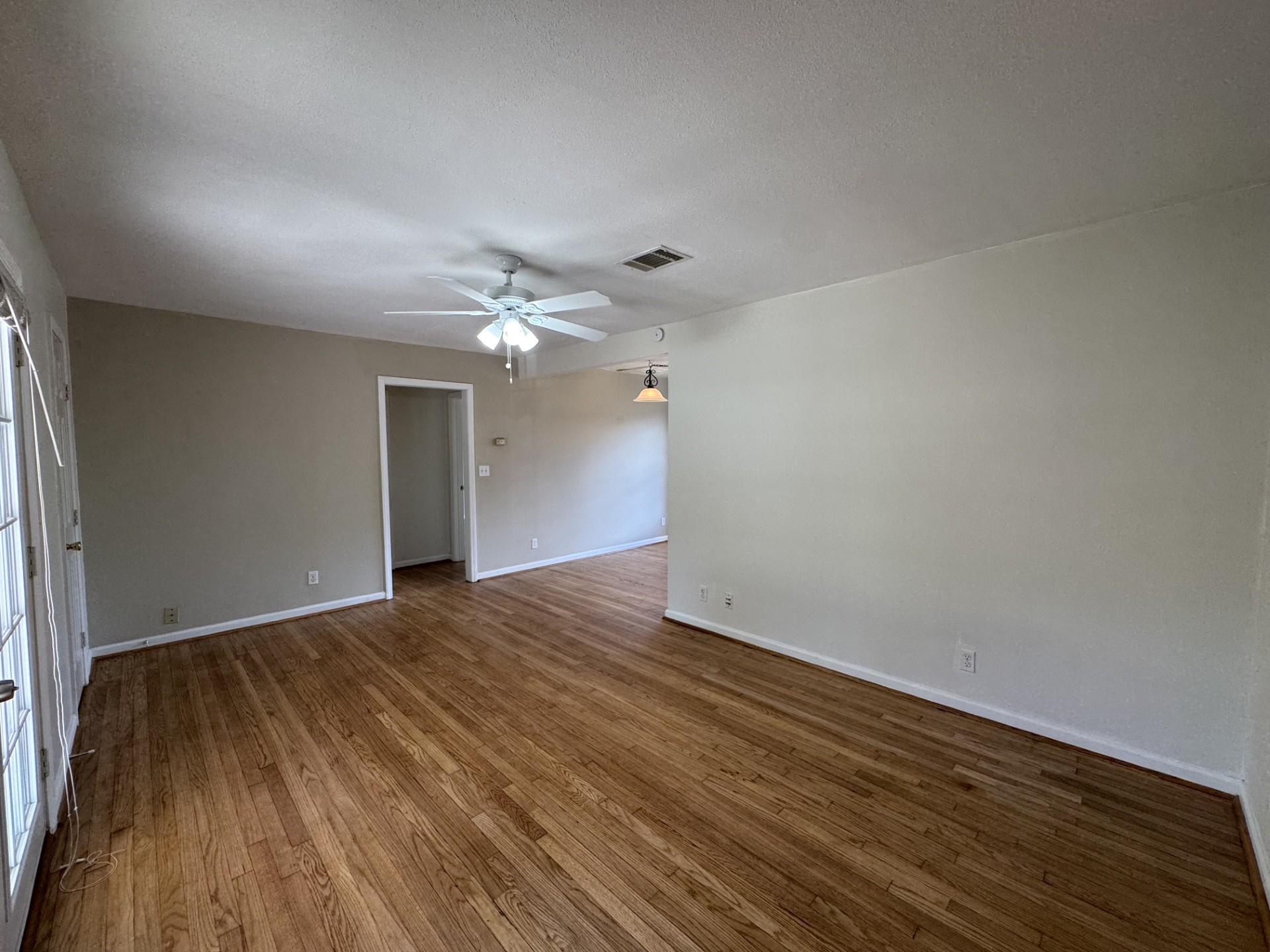 216 Gale Street Houston, TX 77009 - Photo 4 of 12 a view of an empty room with wooden floor