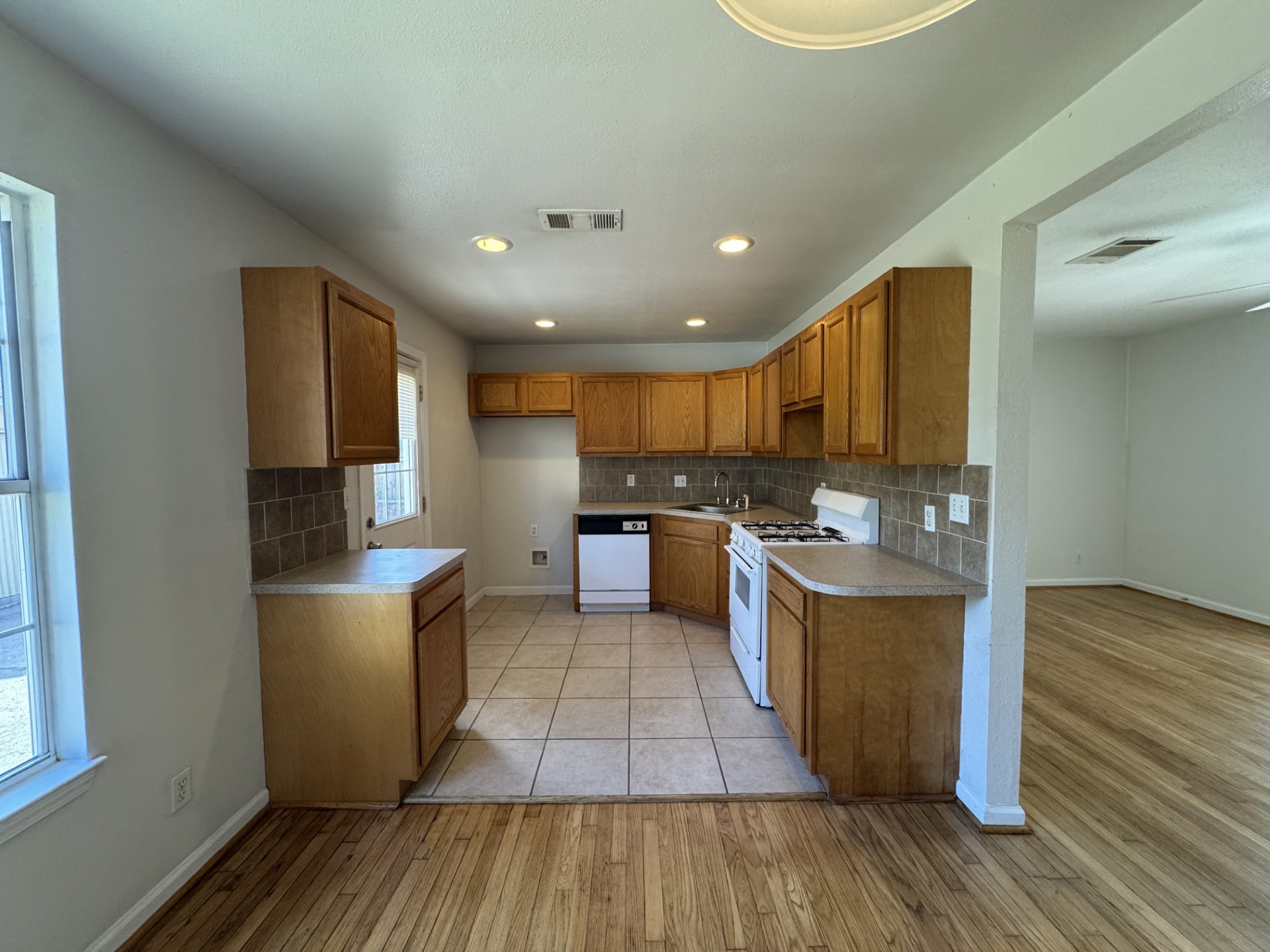 216 Gale Street Houston, TX 77009 - Photo 7 of 12 a kitchen with stainless steel appliances granite countertop a stove a sink and a refrigerator