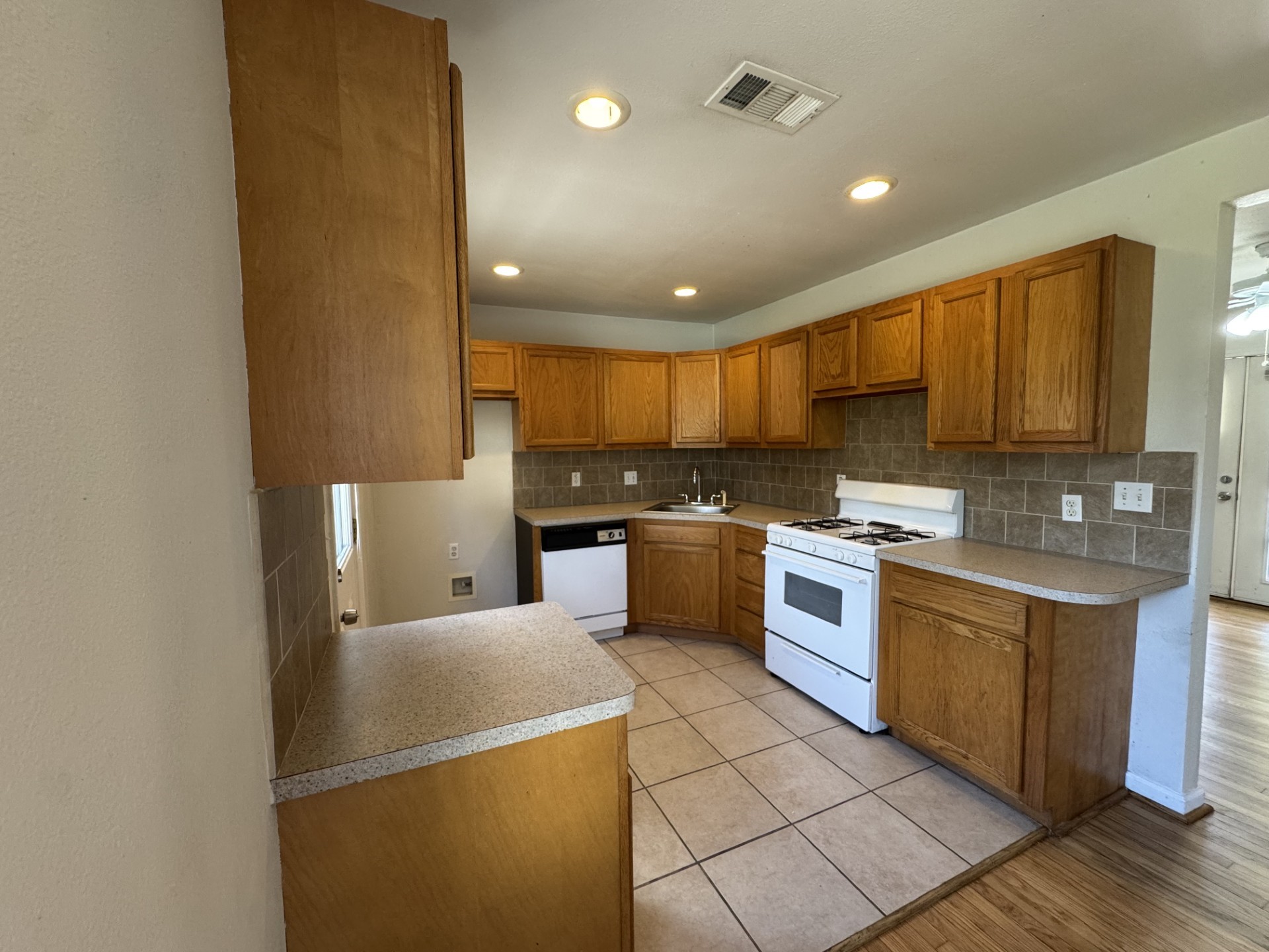 216 Gale Street Houston, TX 77009 - Photo 8 of 12 a kitchen with stainless steel appliances granite countertop a refrigerator a stove top oven a sink and dishwasher
