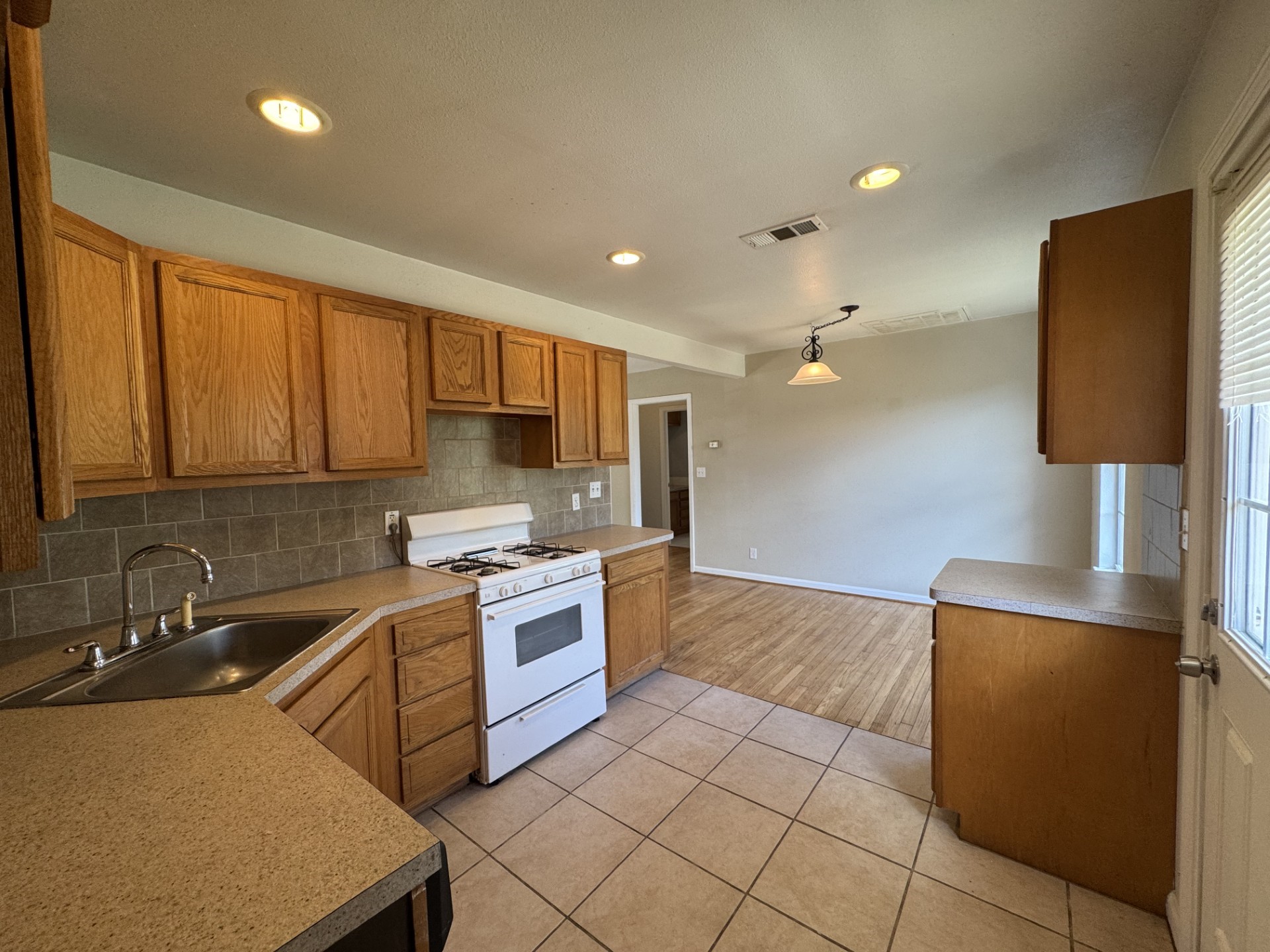 216 Gale Street Houston, TX 77009 - Photo 9 of 12 a kitchen with stainless steel appliances granite countertop a sink stove and refrigerator