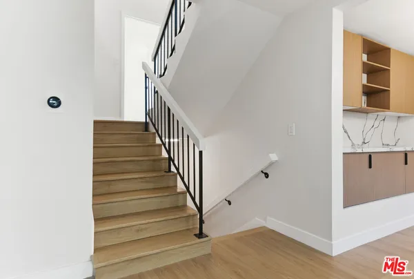 a view of entryway with wooden floor and stairs