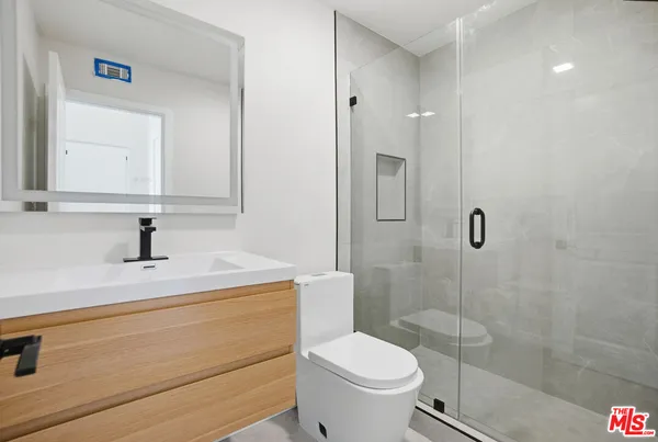 a bathroom with a shower and toilet