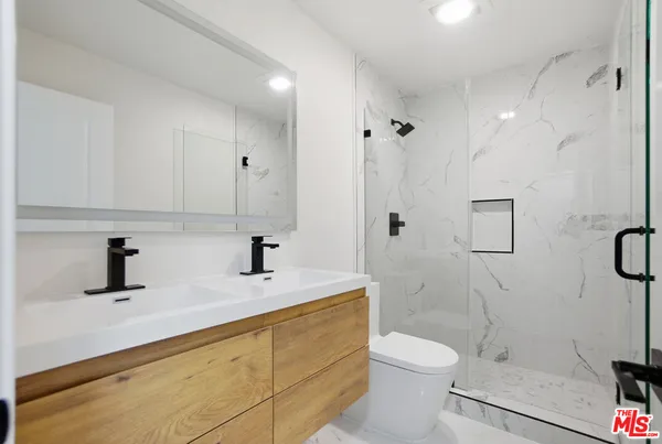 a view of a room that has wooden floor and bench